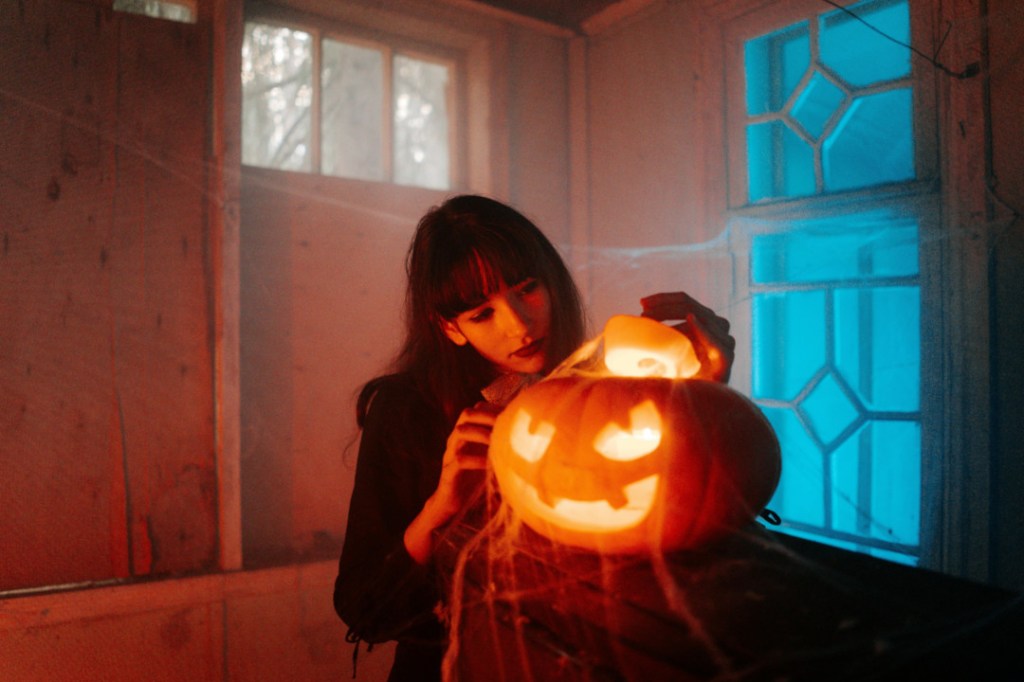 woman with a carved pumpkin
